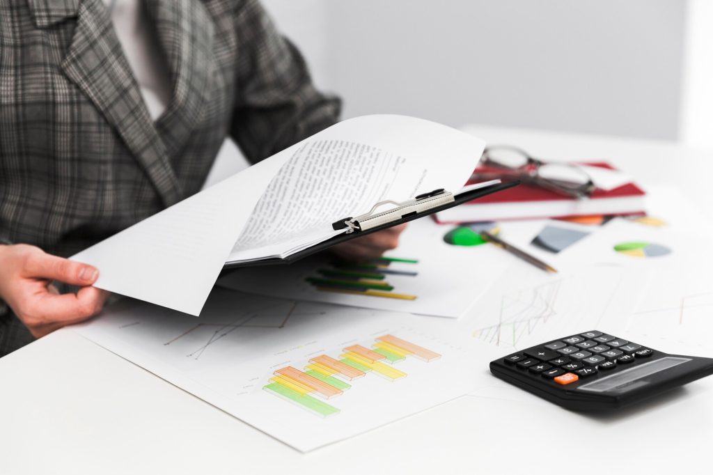 A person analyzing financial paperwork, representing the evaluation process for lowering surety bond rates.