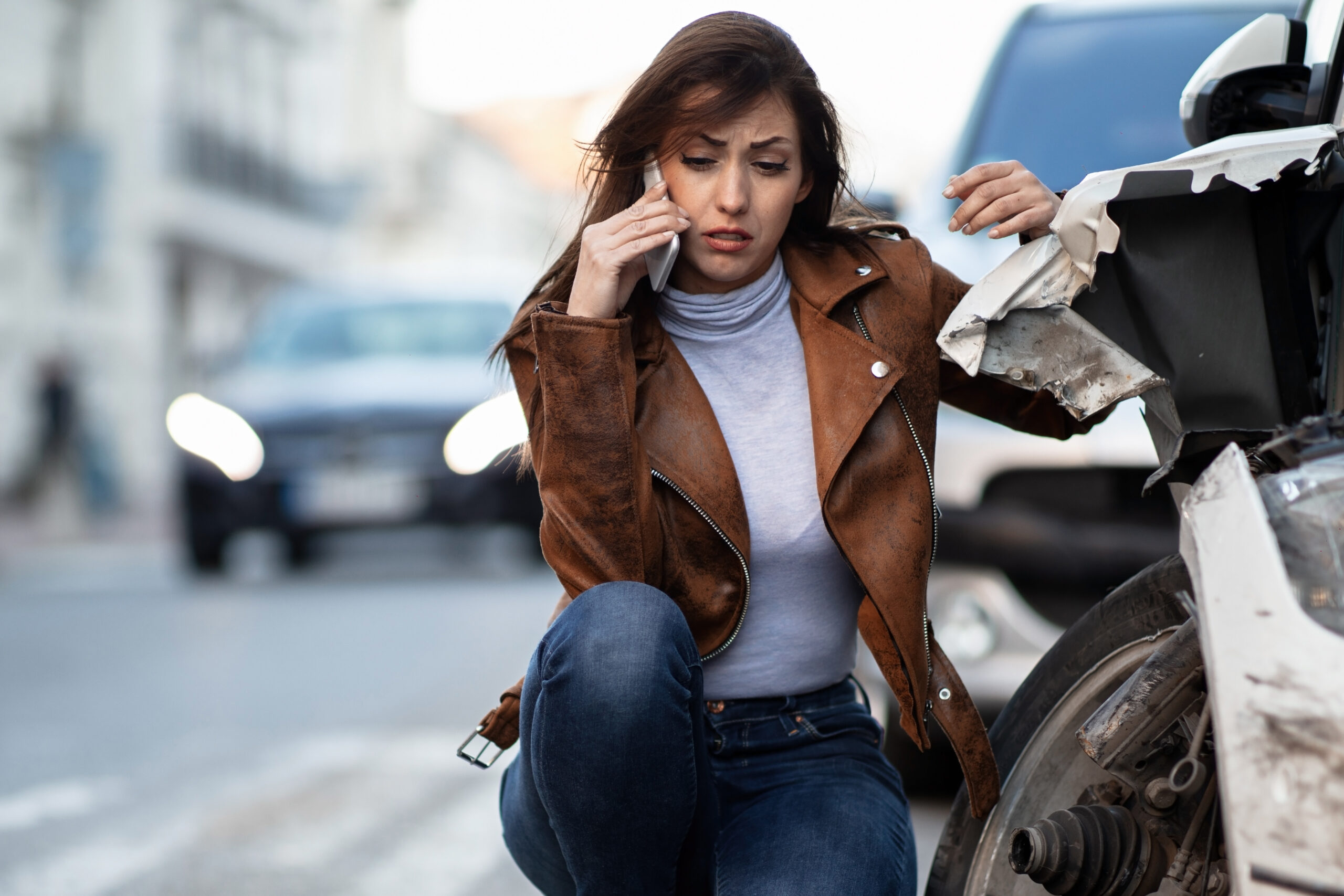 Woman on phone after accident speaking with her auto insurance company